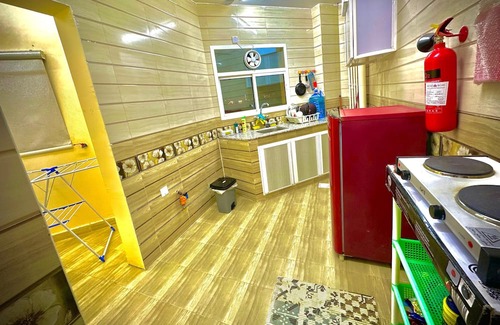 Seeb Apartamento | Bedroom with an attached bathroom, shared kitchen in area with everything around