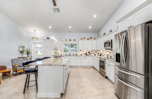 Pine Island Center Casa | Canal-side charmer with enclosed pool, waterside deck, open layout, & W/D