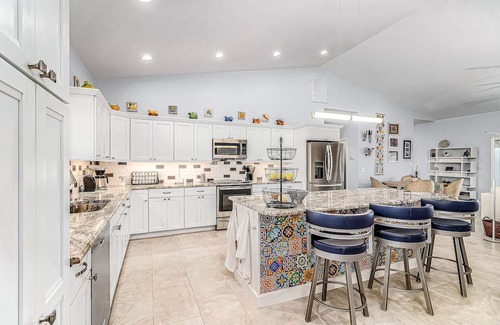 Pine Island Center Casa | Canal-side charmer with enclosed pool, waterside deck, open layout, & W/D