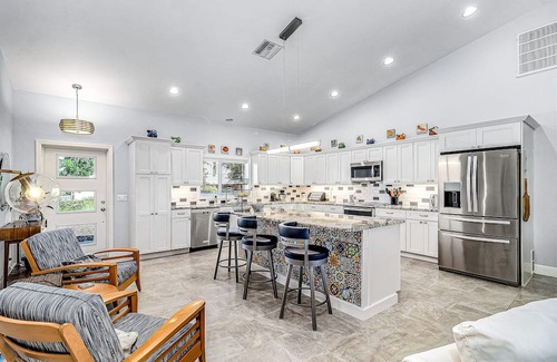 Pine Island Center Casa | Canal-side charmer with enclosed pool, waterside deck, open layout, & W/D