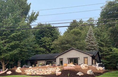 Rapid City Casa | 50 feet of Torch Lake frontage! Boathouse, beautiful patios sweet little beach.
