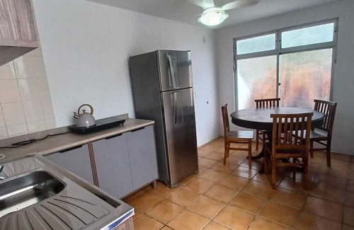 Armacao Apartamento | One bedroom and living room apartment with fully equipped kitchen.