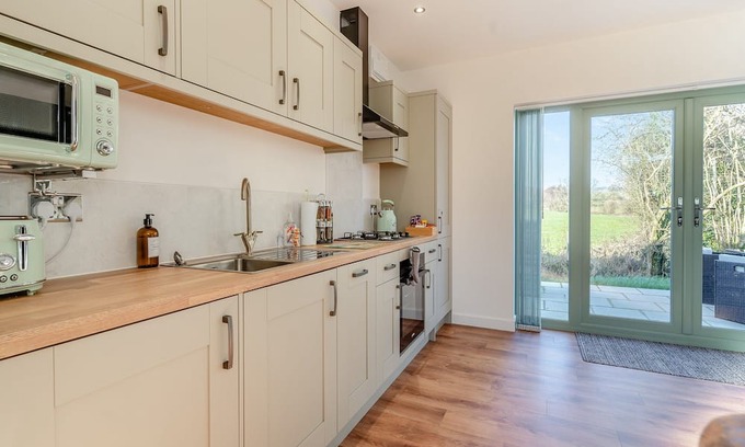 Coed-Y-Paen Cabaña | Fox Acre is a stunning lodge with views over the rolling hills, perfect for a relaxing break away or