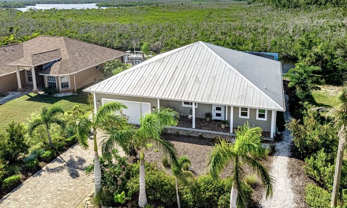 Pine Island Center Casa | Canal-side charmer with enclosed pool, waterside deck, open layout, & W/D