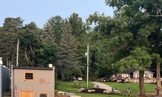 Rapid City Casa | 50 feet of Torch Lake frontage! Boathouse, beautiful patios sweet little beach.
